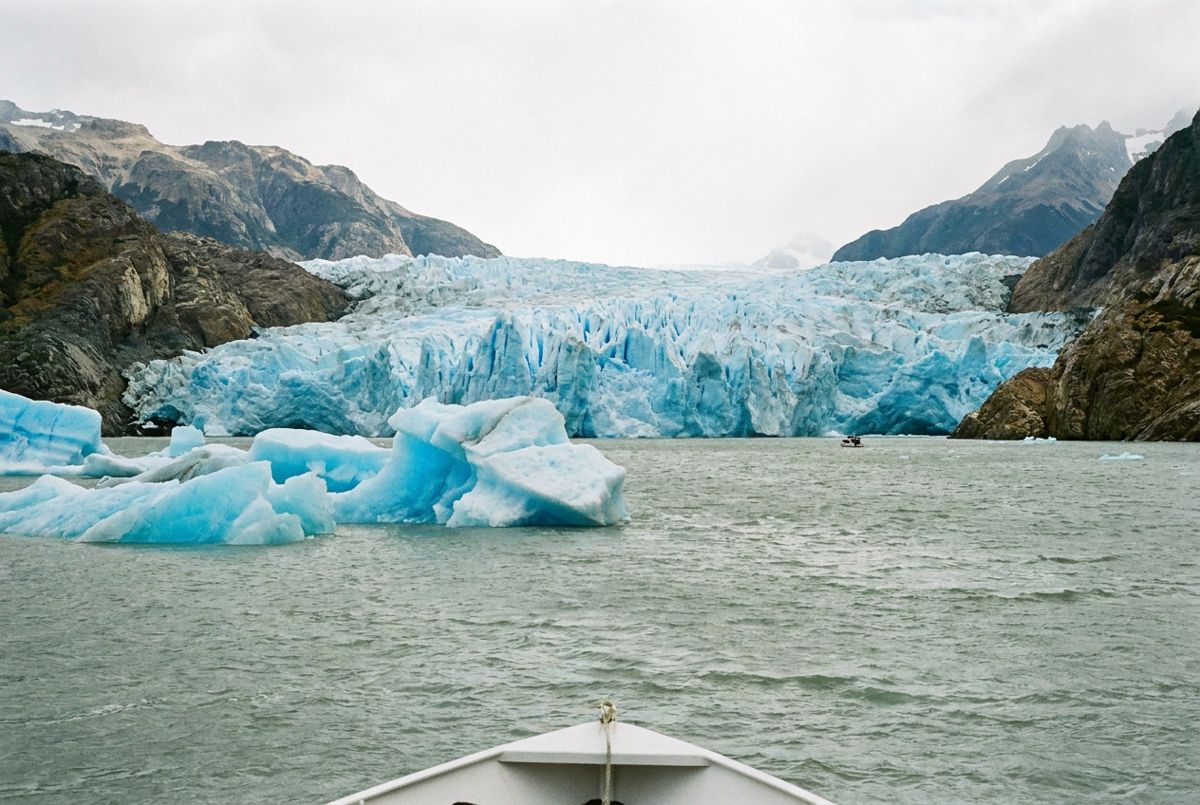 Blue ice face of Grey Glacier with floating icebergs on Lago Grey in Torres del Paine