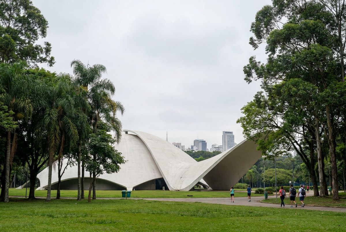 The white Oca dome in Ibirapuera Park surrounded by green lawns and tall trees on a soft morning in São Paulo