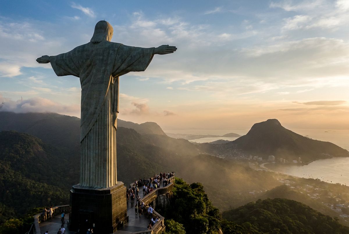 Christ the Redeemer statue on Corcovado with Guanabara Bay and Sugarloaf in the afternoon haze behind