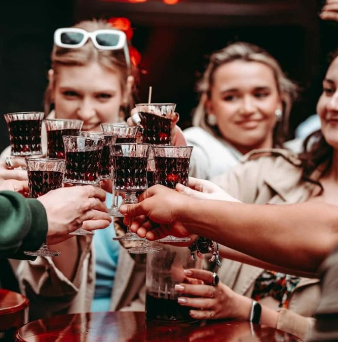 Group toasting with shot glasses on a Krakow food tour