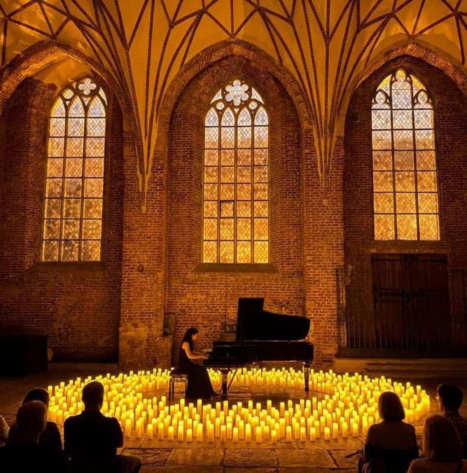 Pianist among candles inside a Gothic church in Gdansk