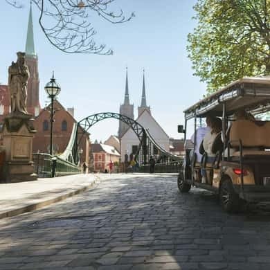 Electric car tour passing the cathedral on Ostrów Tumski in Wroclaw
