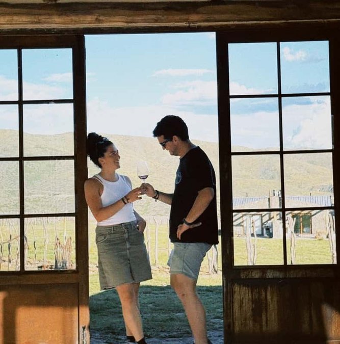 Couple tasting wine at a window overlooking the Uco Valley