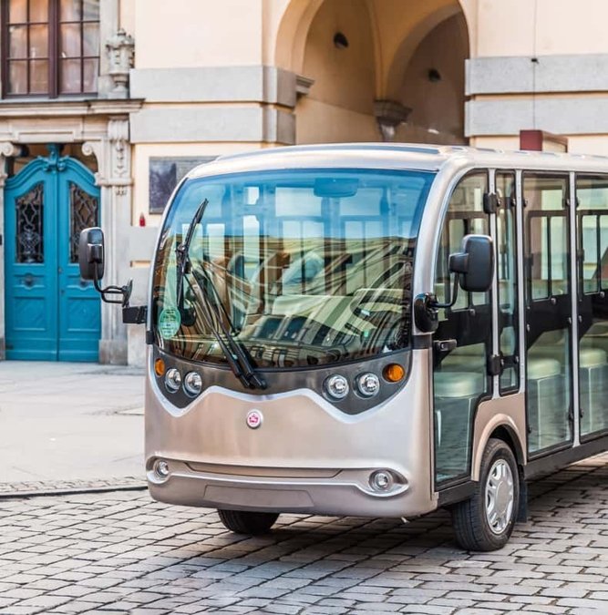 Silver electric sightseeing car parked in a Wroclaw courtyard