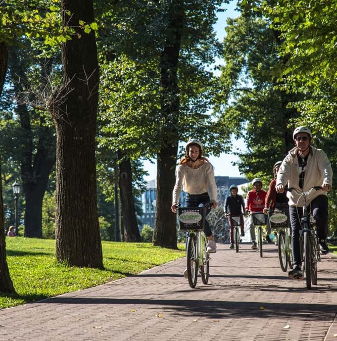 Cyclists on a tree-lined path in Buenos Aires
