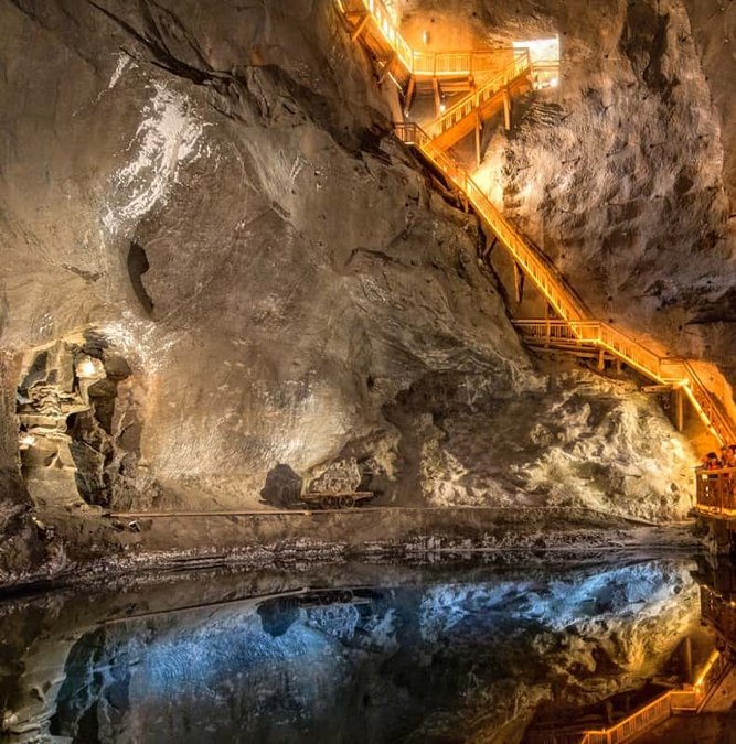 Underground salt lake lit in orange inside the Wieliczka mine