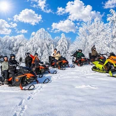 Row of snowmobiles in a snowy Tatra forest