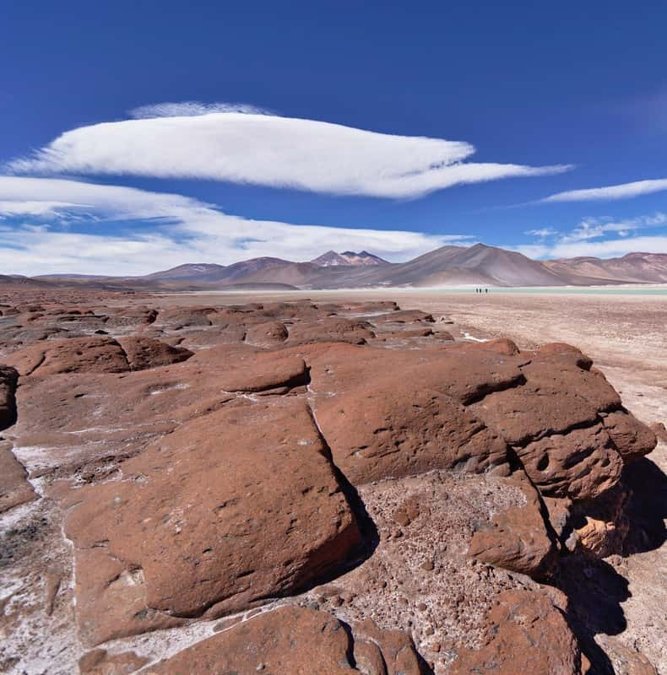 Red stones and a turquoise lagoon in the Atacama highlands