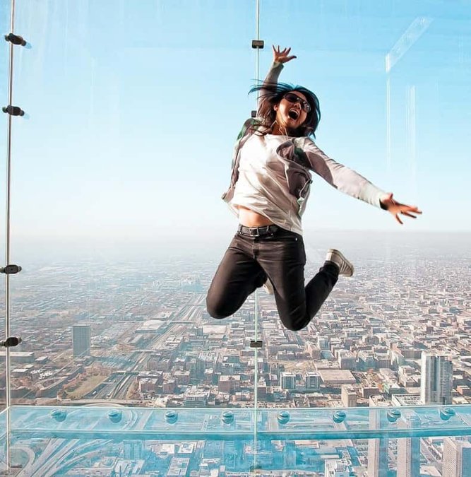 Visitor jumping on the glass Ledge of the Willis Tower Skydeck