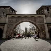Stone gate in Munich old town at dusk