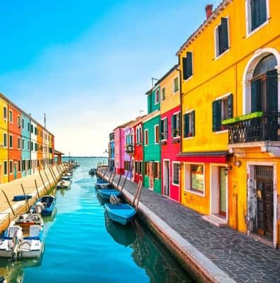 Brightly painted houses along a canal on Burano island