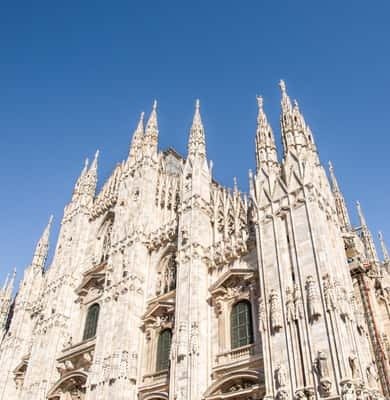 Spires of Milan Cathedral against a blue sky