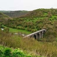 Stone viaduct in the green hills of the Peak District