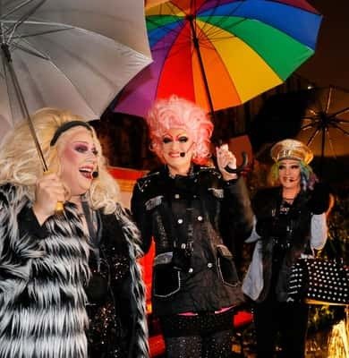 Performers under a rainbow umbrella on the Reeperbahn