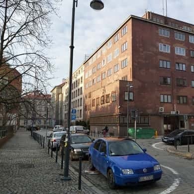 Tree-lined street of prewar brick tenements in Wroclaw