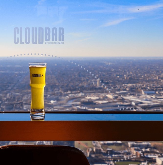Beer on the window ledge of 360 Chicago above the city