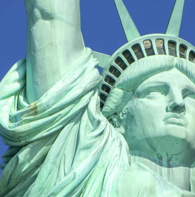 Close-up of the Statue of Liberty against a blue sky