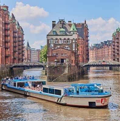 Cruise boat passing the red-brick warehouses of the Speicherstadt