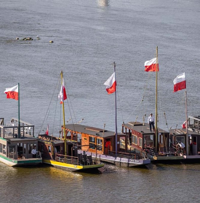 Traditional galar boats with Polish flags on the Vistula