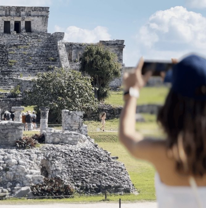 Traveler photographing the Tulum ruins