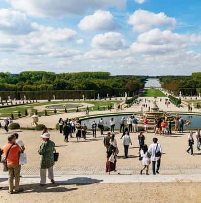 Visitors on the gravel paths of the Versailles gardens