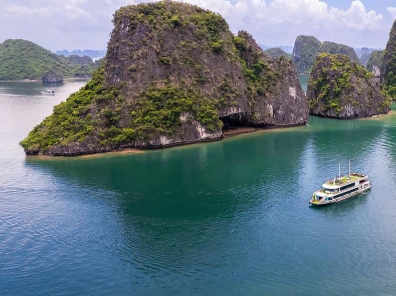 A cruise boat among the limestone islands of Ha Long Bay