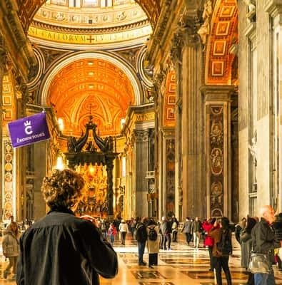 Gilded interior of St. Peter's Basilica with visitors