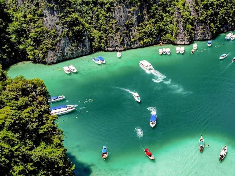 Speedboats anchored in the turquoise lagoon of Phi Phi Leh