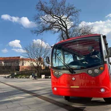 Red electric golf cart on a Krakow square