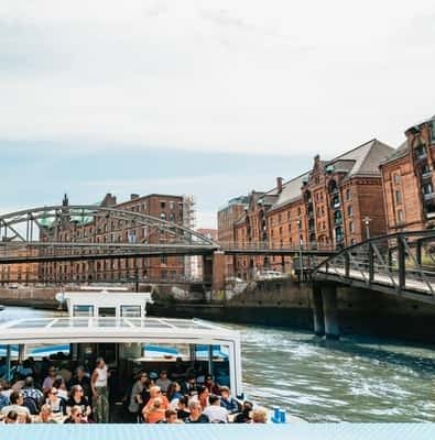 Harbor cruise boat under a bridge in Hamburg