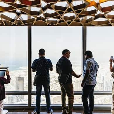Visitors looking out over Dubai from the Burj Khalifa Sky level
