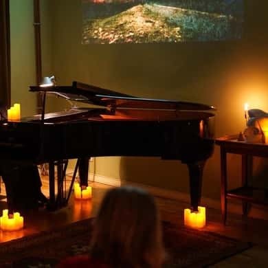 Grand piano lit by candles at a Chopin concert in Warsaw