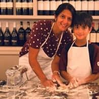 Mother and child kneading pasta dough in a Venice class