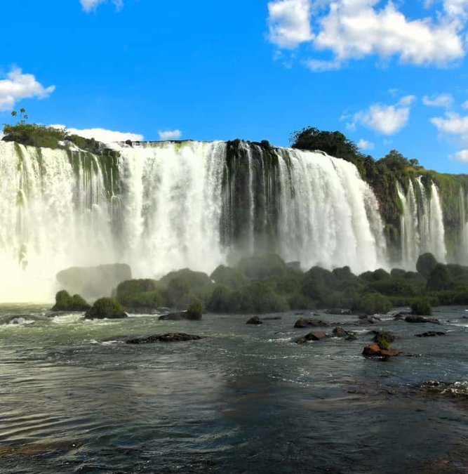Wide curtain of Iguazu Falls under a clear sky