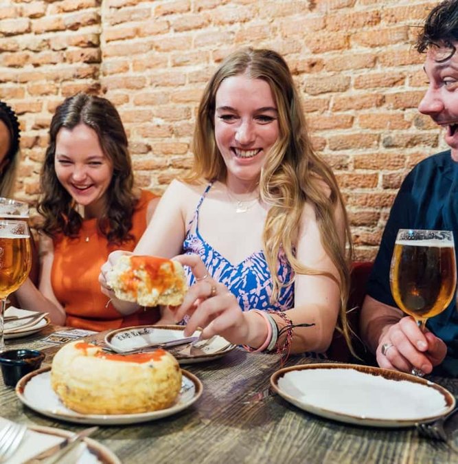 Friends sharing tapas and wine in a Madrid tavern