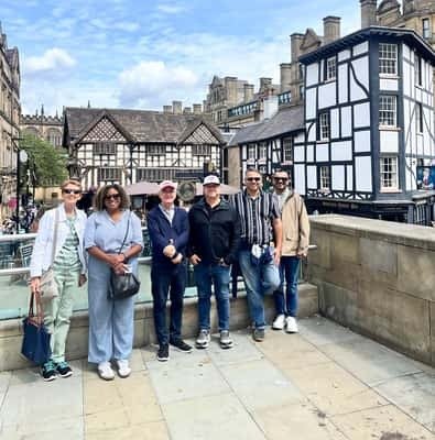 Tour group in front of a half-timbered Manchester pub