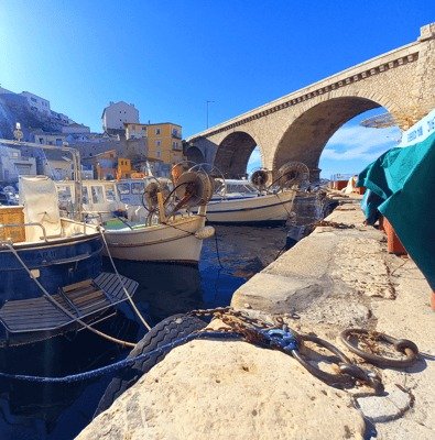 Fishing boats in the Vallon des Auffes under the bridge