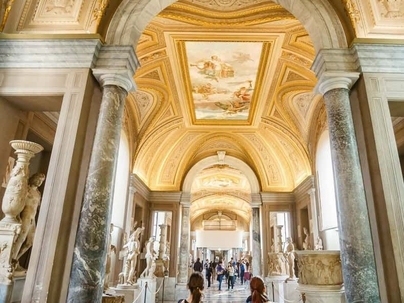 The painted vaulted gallery of the Vatican Museums filled with visitors