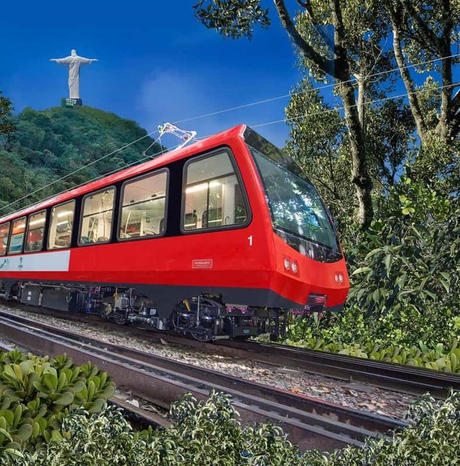 Red cog train climbing through the forest to Christ the Redeemer