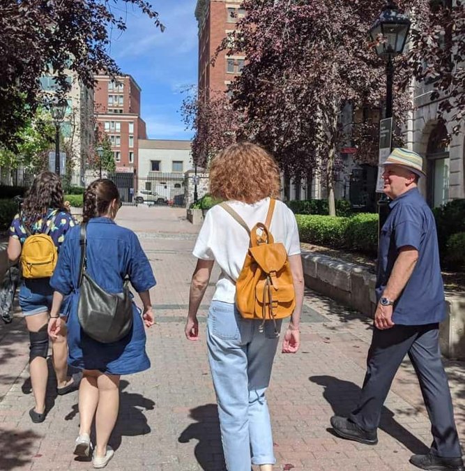 Travelers walking a cobblestone street in Old Montreal
