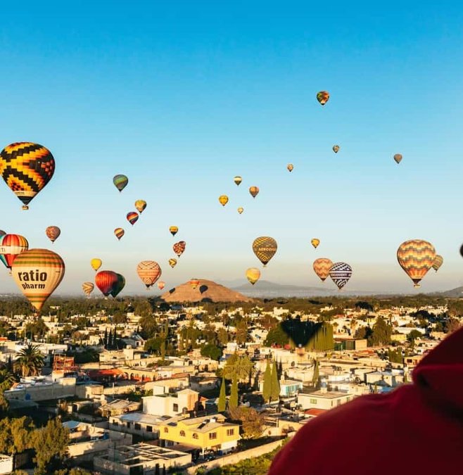 Hot-air balloons rising over Teotihuacan at dawn
