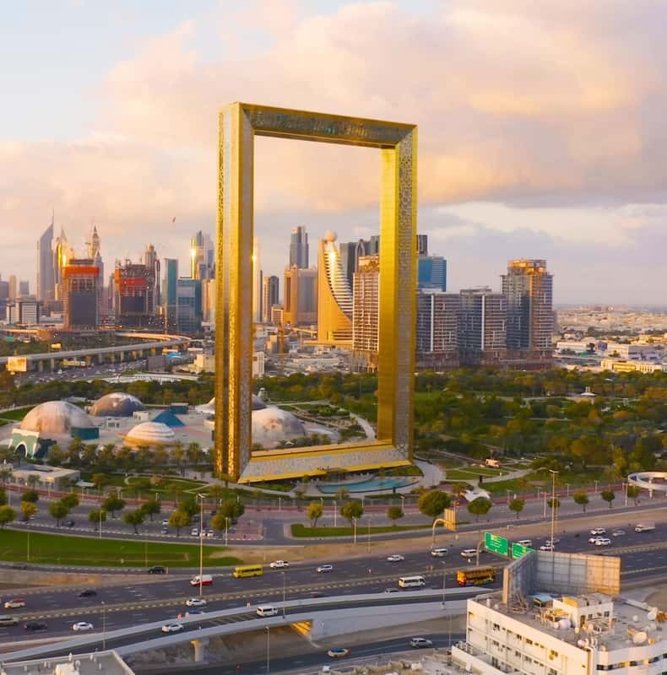 The golden Dubai Frame against a blue sky