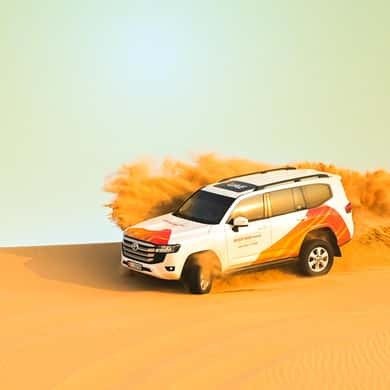 4x4 driving over orange dunes near Abu Dhabi