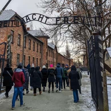 Visitors walking past the brick blocks of Auschwitz I