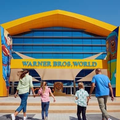 Family outside the entrance of Warner Bros. World on Yas Island