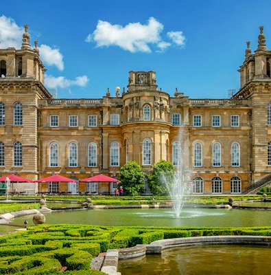 Blenheim Palace gardens with fountains and historic architecture, London tour.