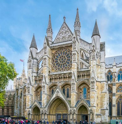 Westminster Abbey facade with visitors, London.