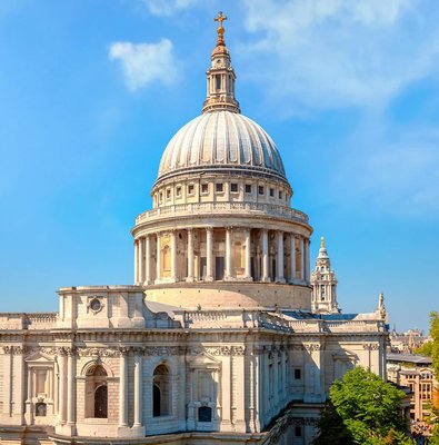St. Paul's Cathedral dome with London skyline on a sunny day.