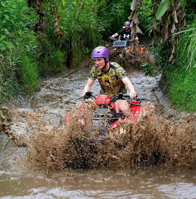Quad biking through muddy trails in Bali.