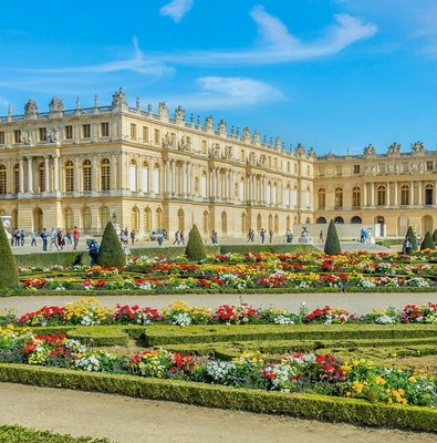 Palace of Versailles with ornate architecture and expansive gardens in France.